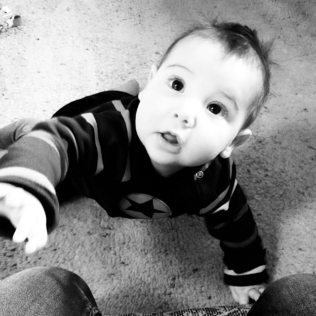 a black and white po of a small boy on the floor