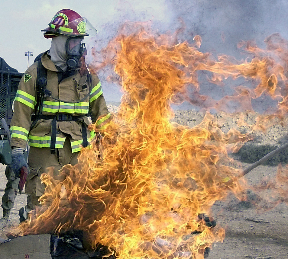 a firefighter holding up the flames on a boat