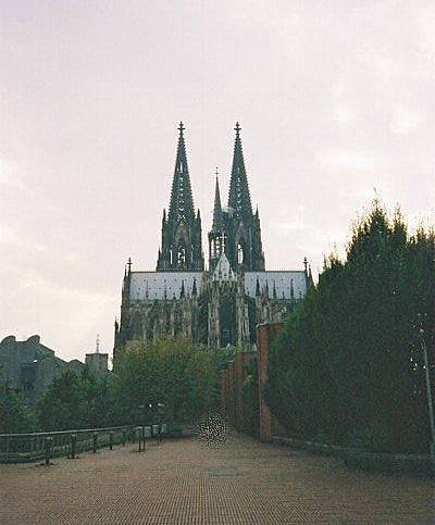 an old, medieval cathedral is seen at dusk