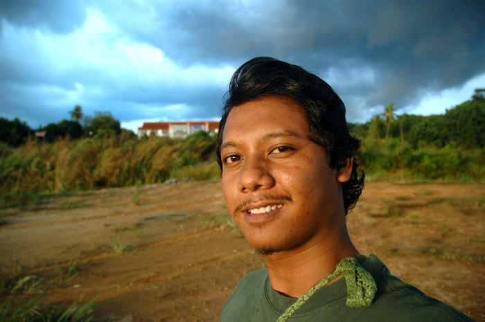 man with short hair wearing a green shirt