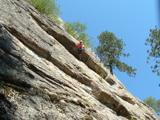 a person is climbing up a rock wall