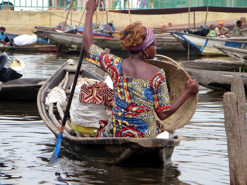 a woman sitting in a boat on a river