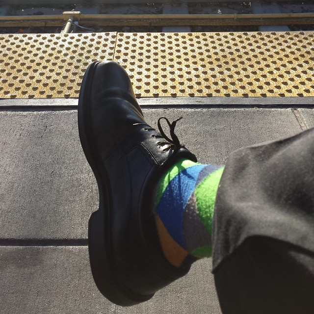 a man in striped socks and black boots