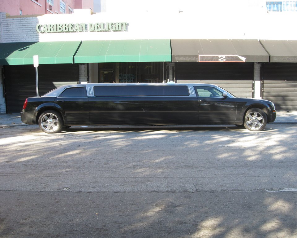 a limousine parked on the street next to a building