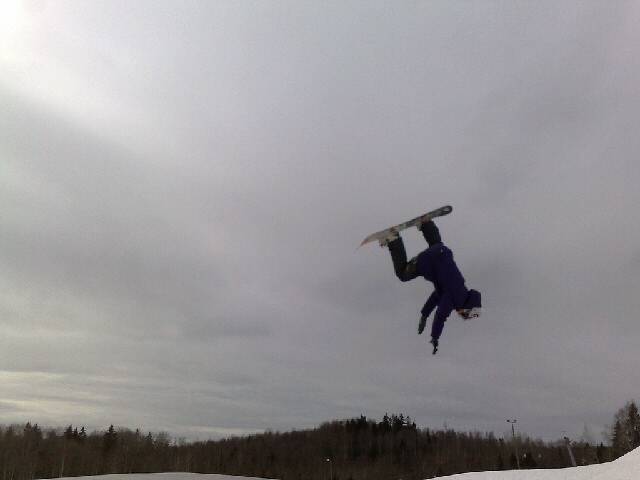 a snowboarder does a flip down in the air