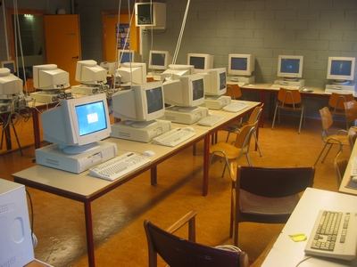 rows of old computer monitors in the room