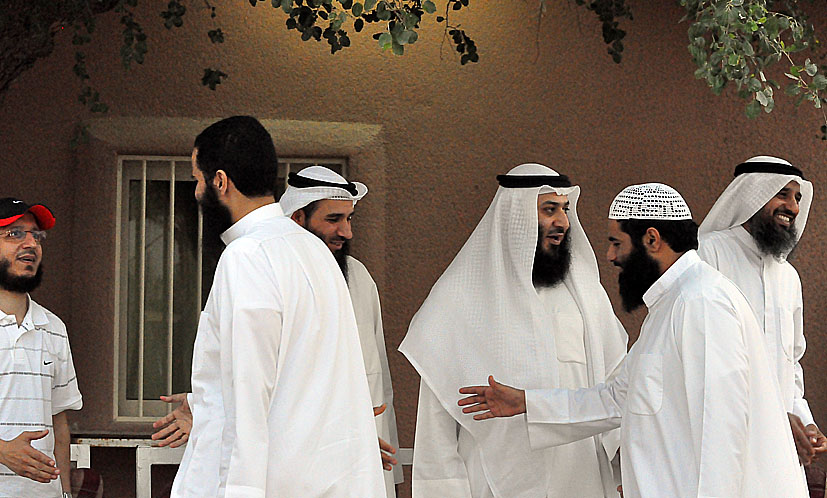 many men dressed in white talking to each other