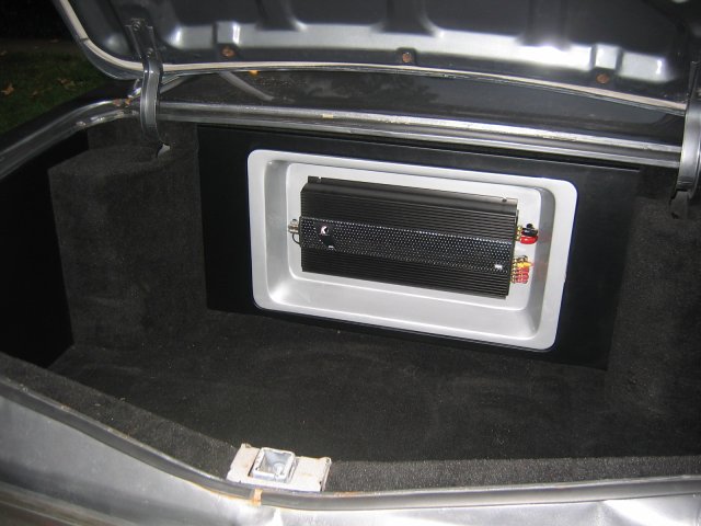 the trunk compartment in an old car with its back doors closed