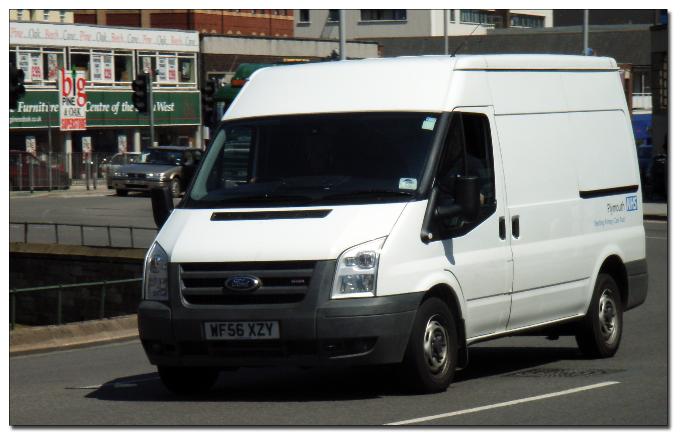 a white van parked in a parking spot with other cars