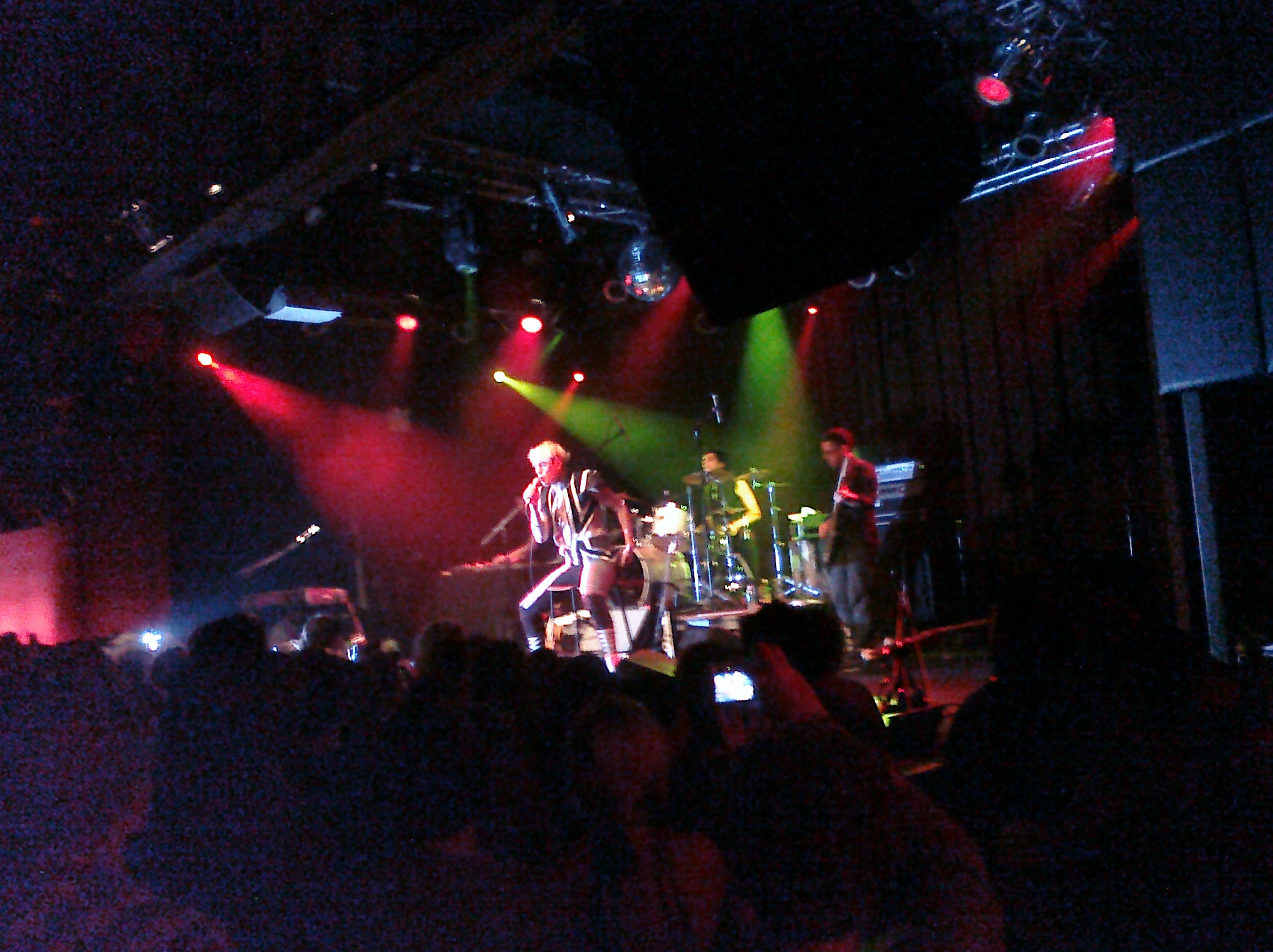 the crowd watching band perform in the dark