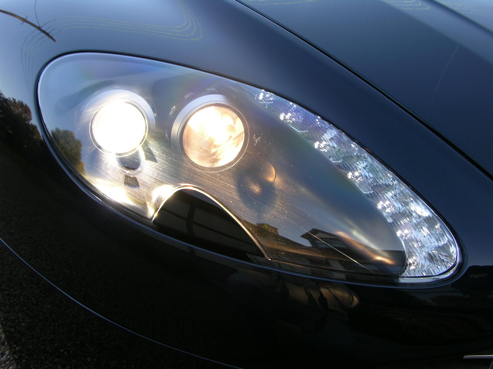 a close up of a shiny chrome car with lights on