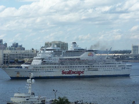 cruise ship with large blue hulls traveling across water