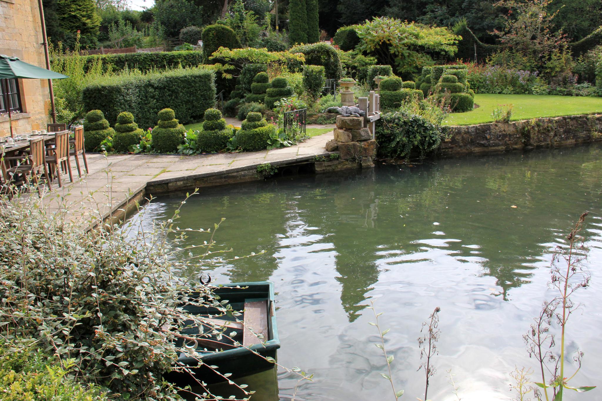 the pond in the garden is clear and sunny