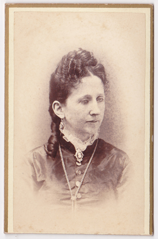 an old po of a young woman with her hair ided