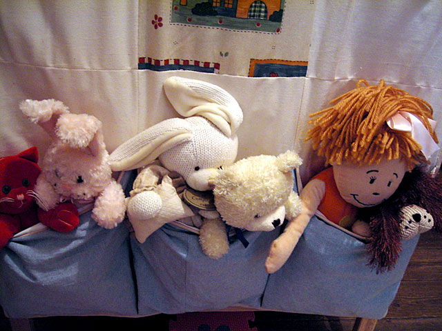 stuffed animals lined up in the back of a suitcase