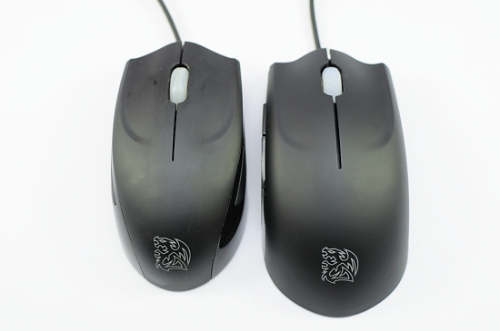 a couple of computer mouses with a tiger logo on them