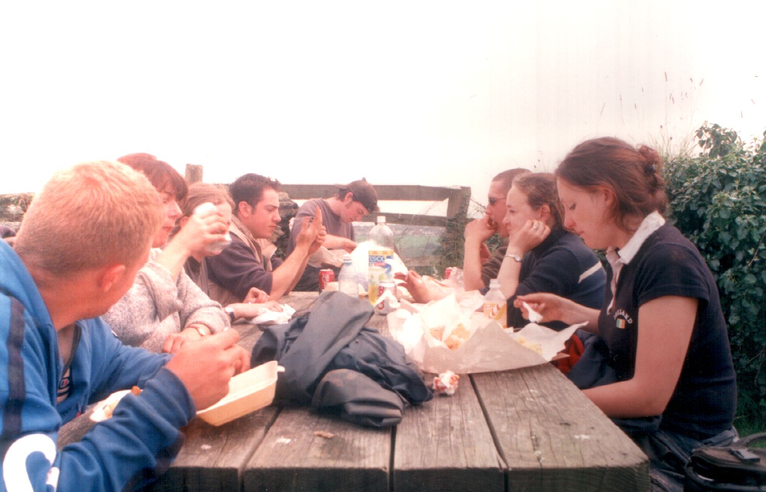 a group of people sitting around a picnic table