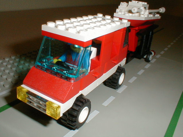 lego model truck with a large motor on top of the back