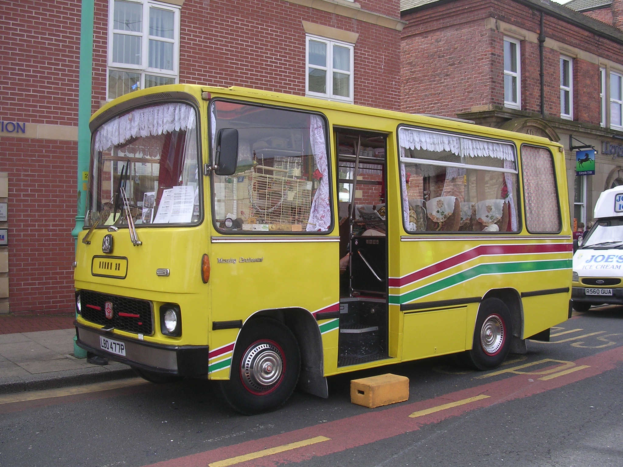 a yellow bus stopped on the side of the street