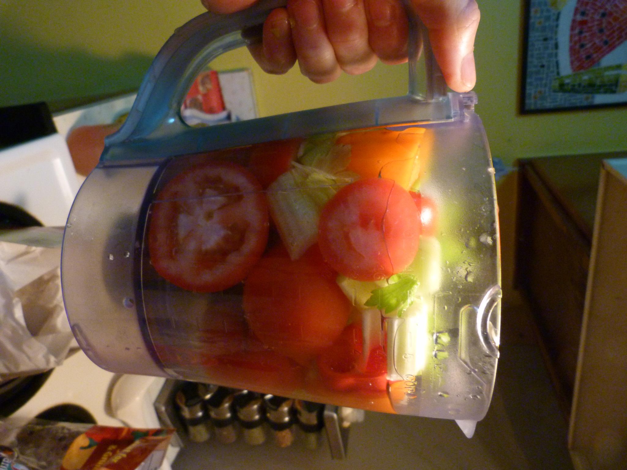 a blender with a mixture of fresh fruits and vegetables in it