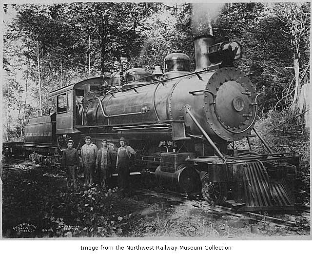 two men and a train on a track in the woods