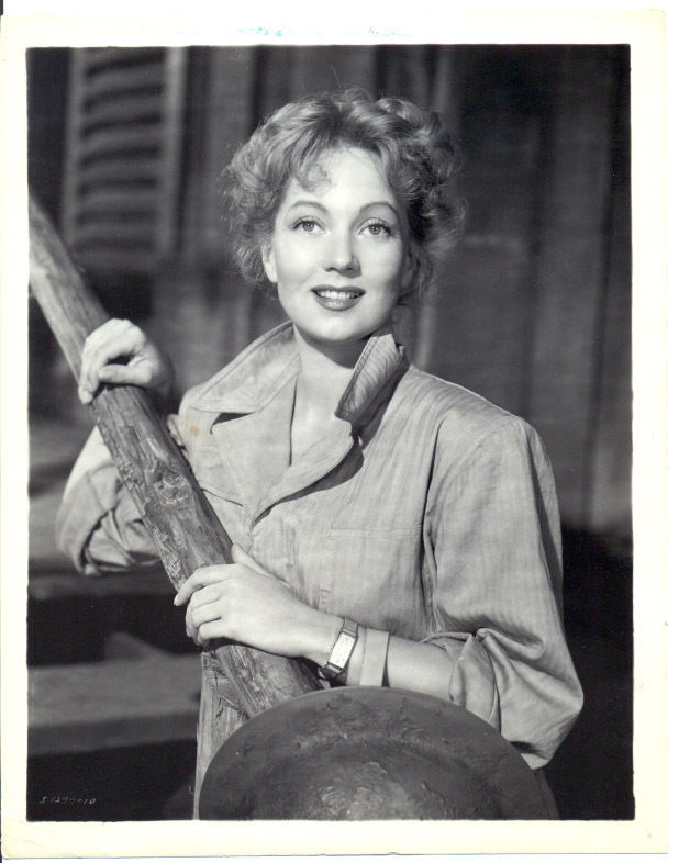 black and white pograph of woman leaning against a railing