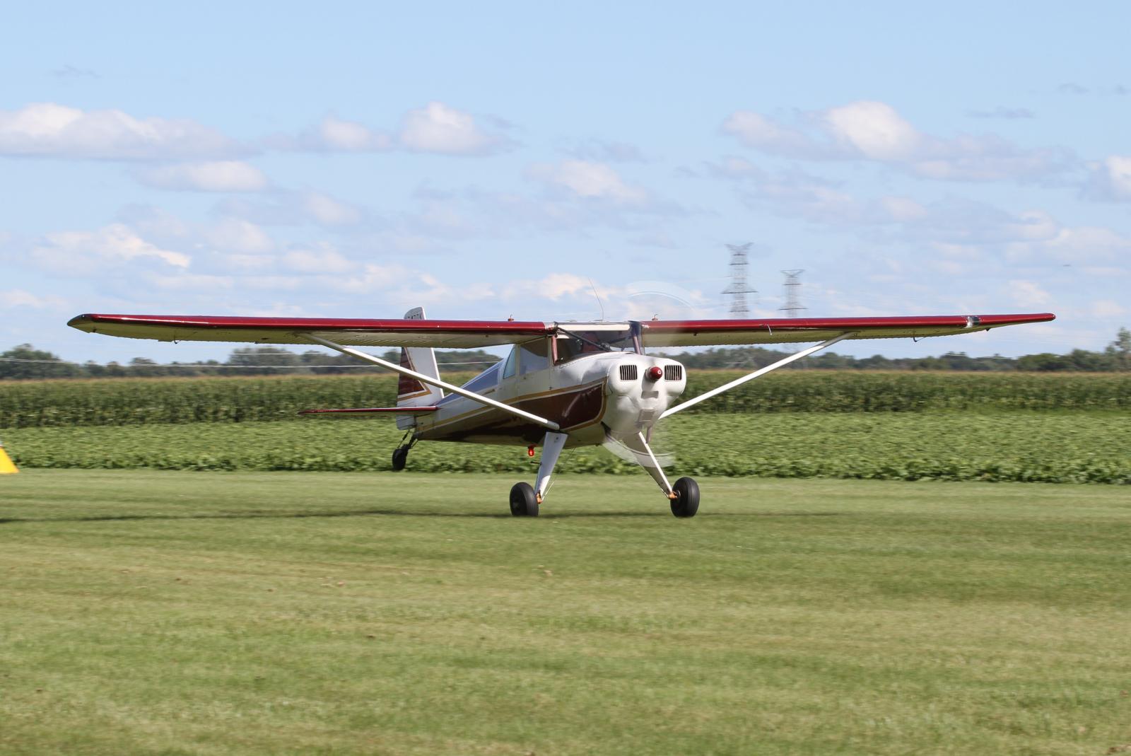 a small single engine plane on a grass field