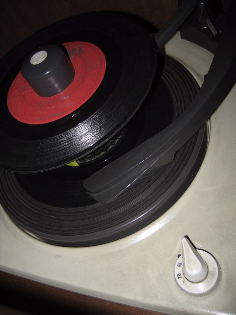 close up of an old vintage record player with the red disk on top