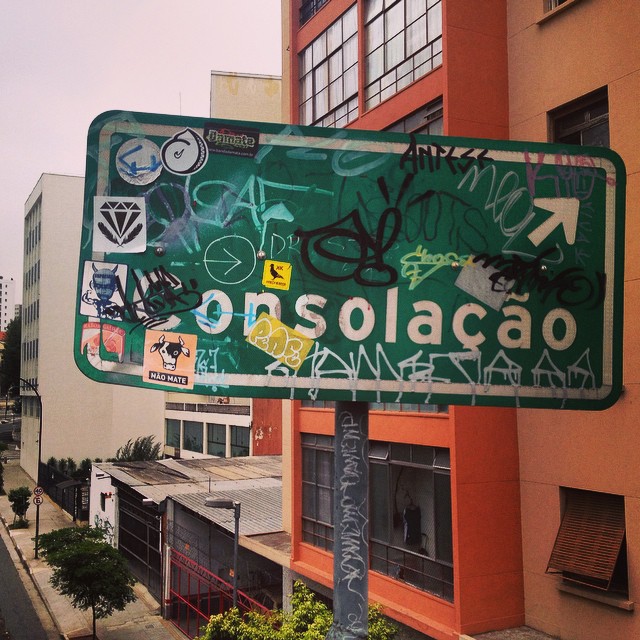 street sign showing the name and numbers of many towns in mexico