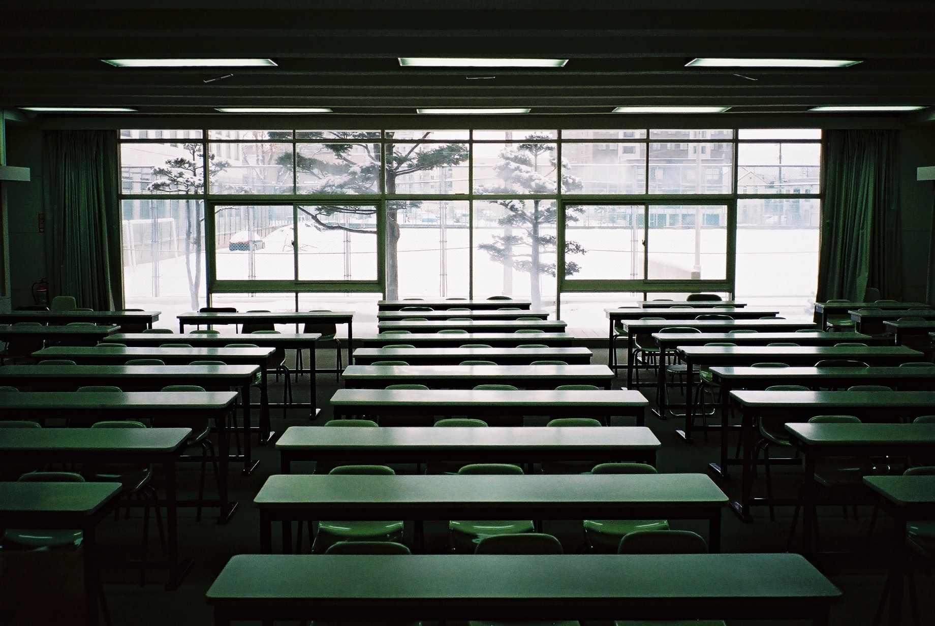 empty classroom with table and green chairs