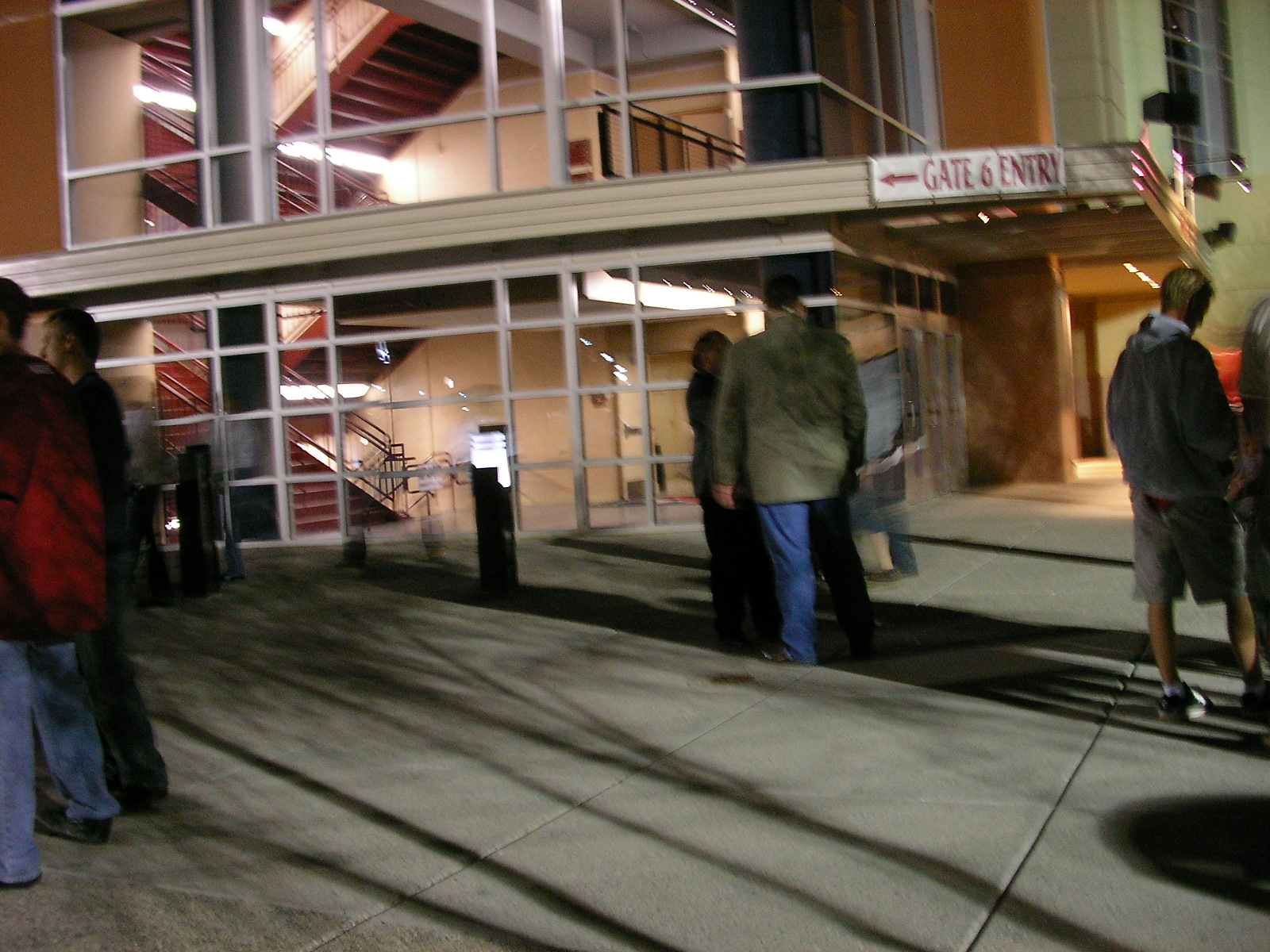 a group of men standing in front of a el building