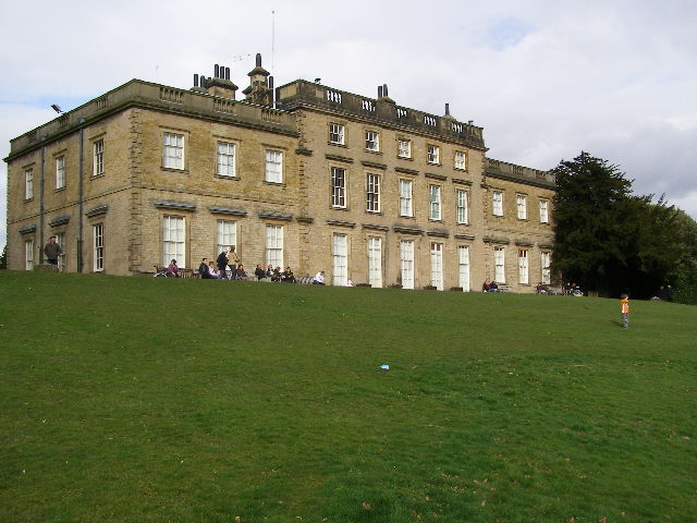 a very large building with people on the lawn