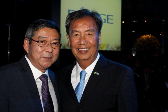 two business men standing side by side in suits