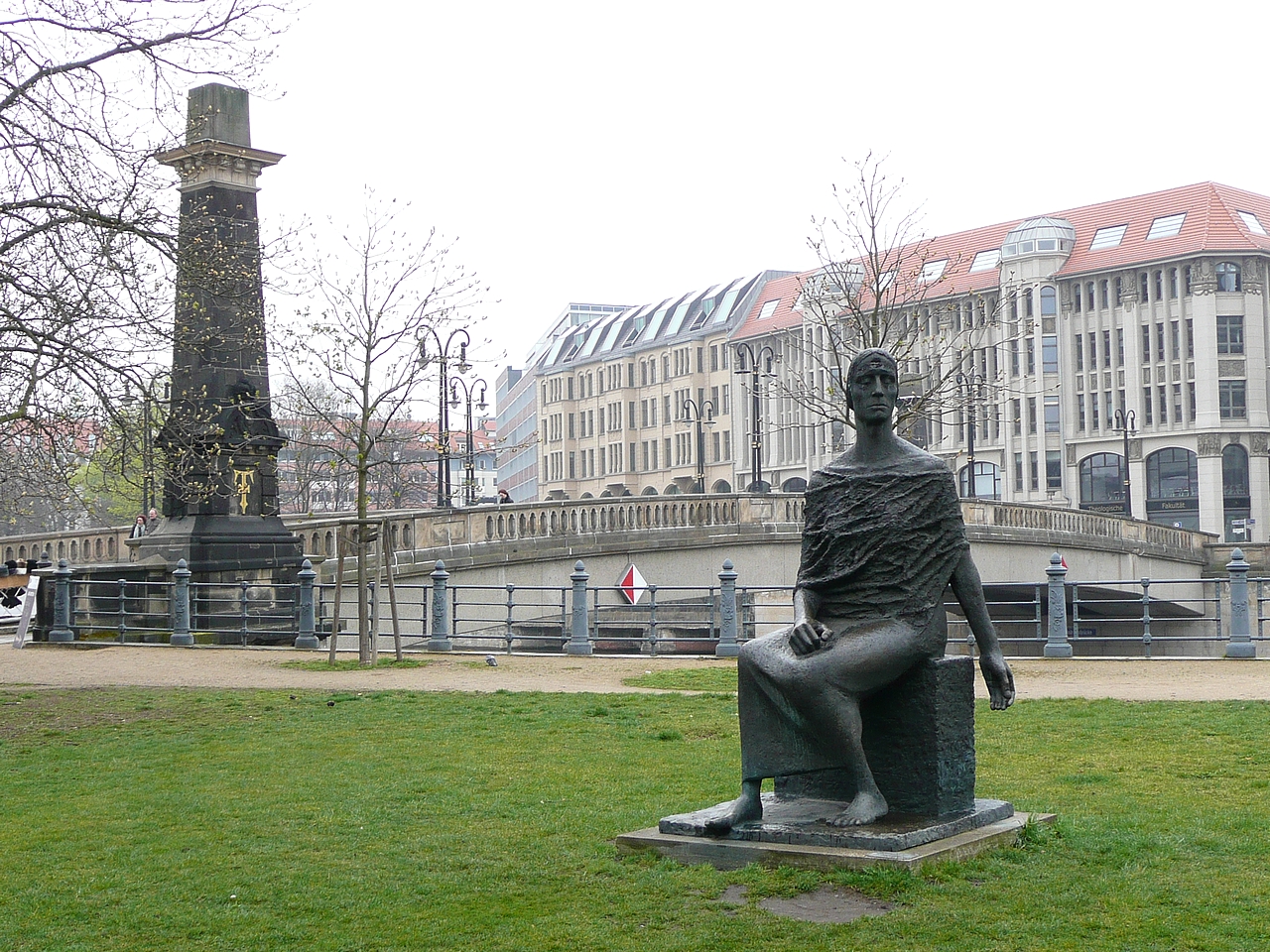 the statue is on display in the park by the water