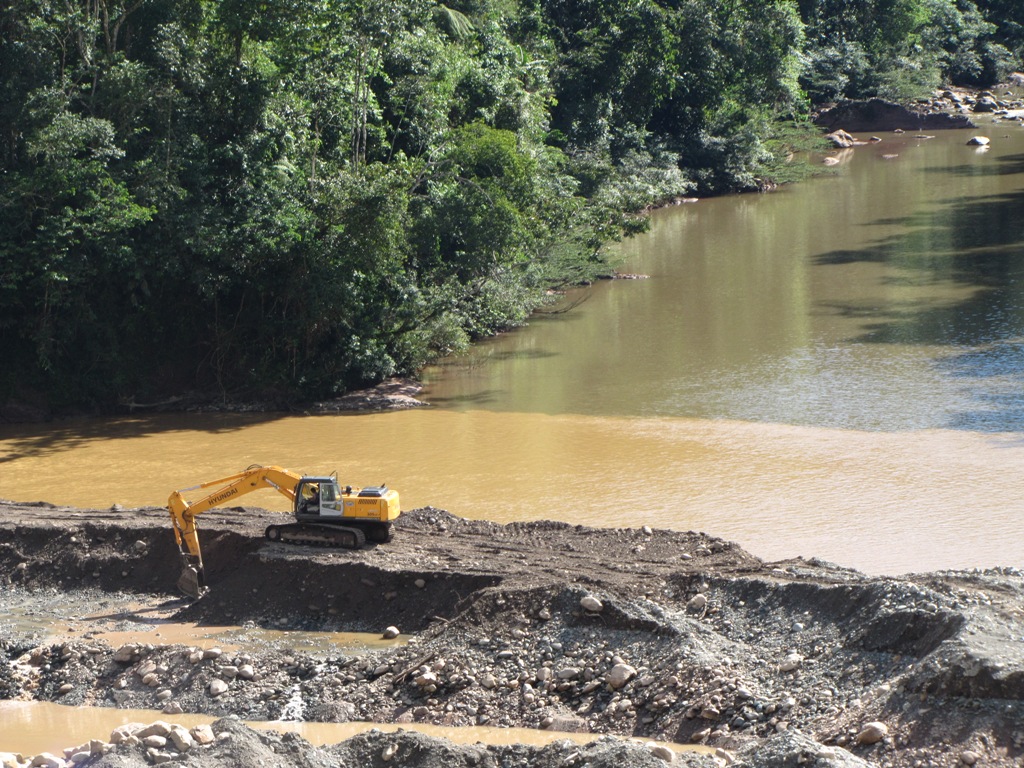 construction equipment is set up on a bank in front of the water