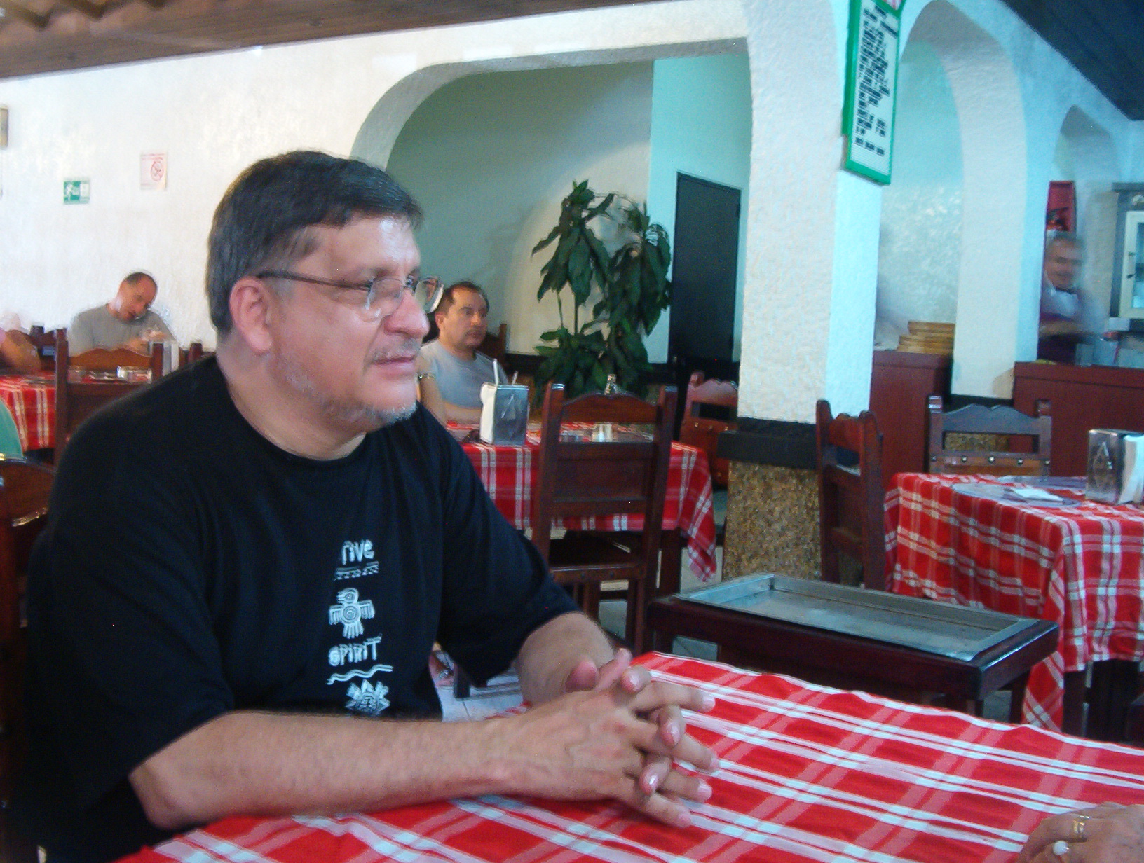 a man sits at a table in front of another person