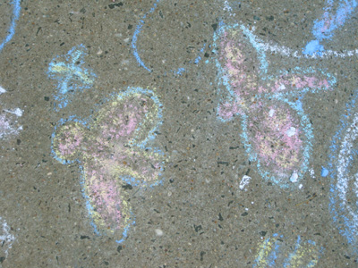 a group of colored chalk drawings sitting on the sidewalk