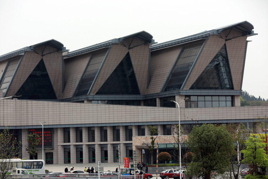 a large, modern building with multiple triangular windows in the middle of a square