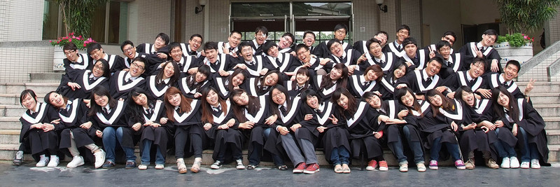 group pograph in front of school graduation gowns