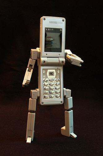 an old phone and a robot on display