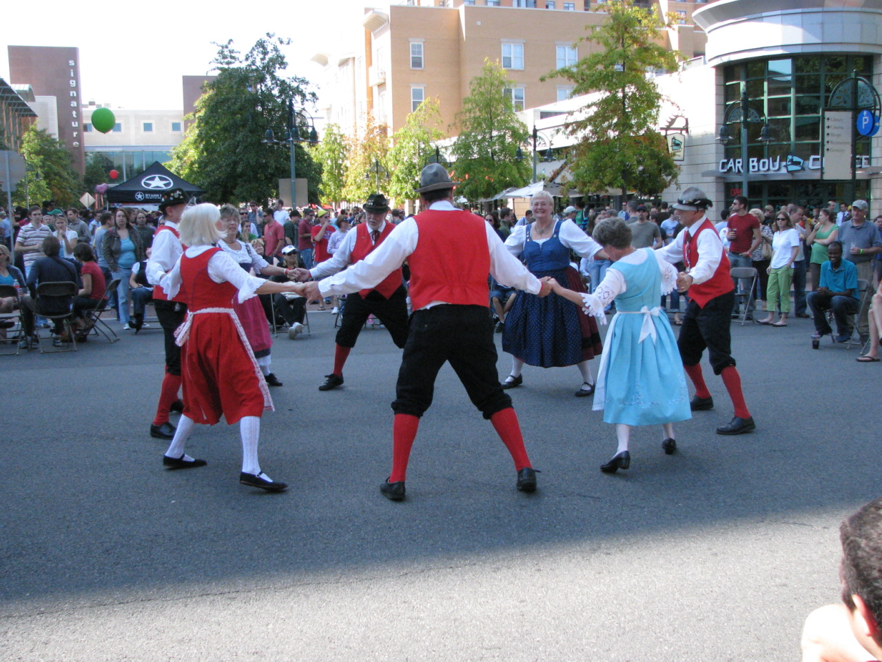many people in costume dancing on the street