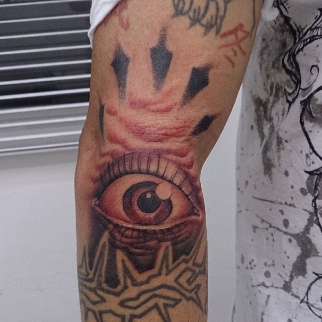 a person with tattoos and an eye