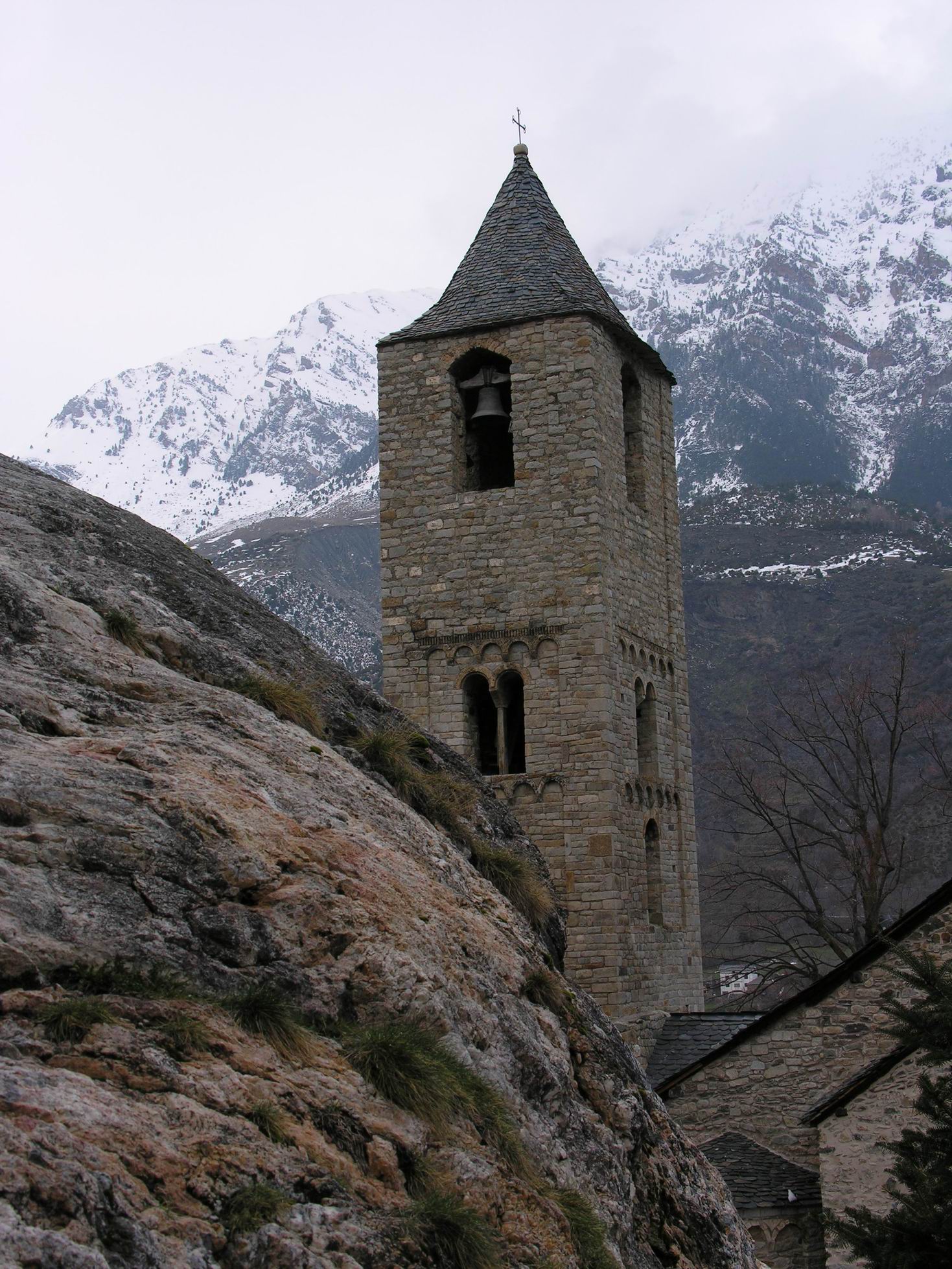 a stone building stands on the side of a mountain