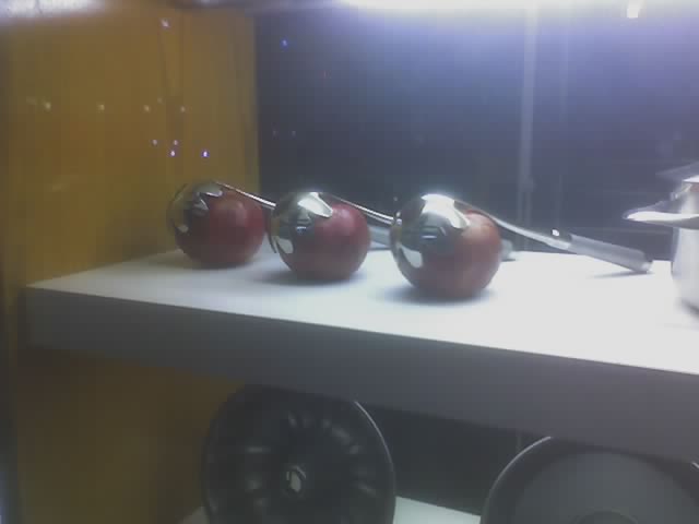 three apples are lined up on a counter top