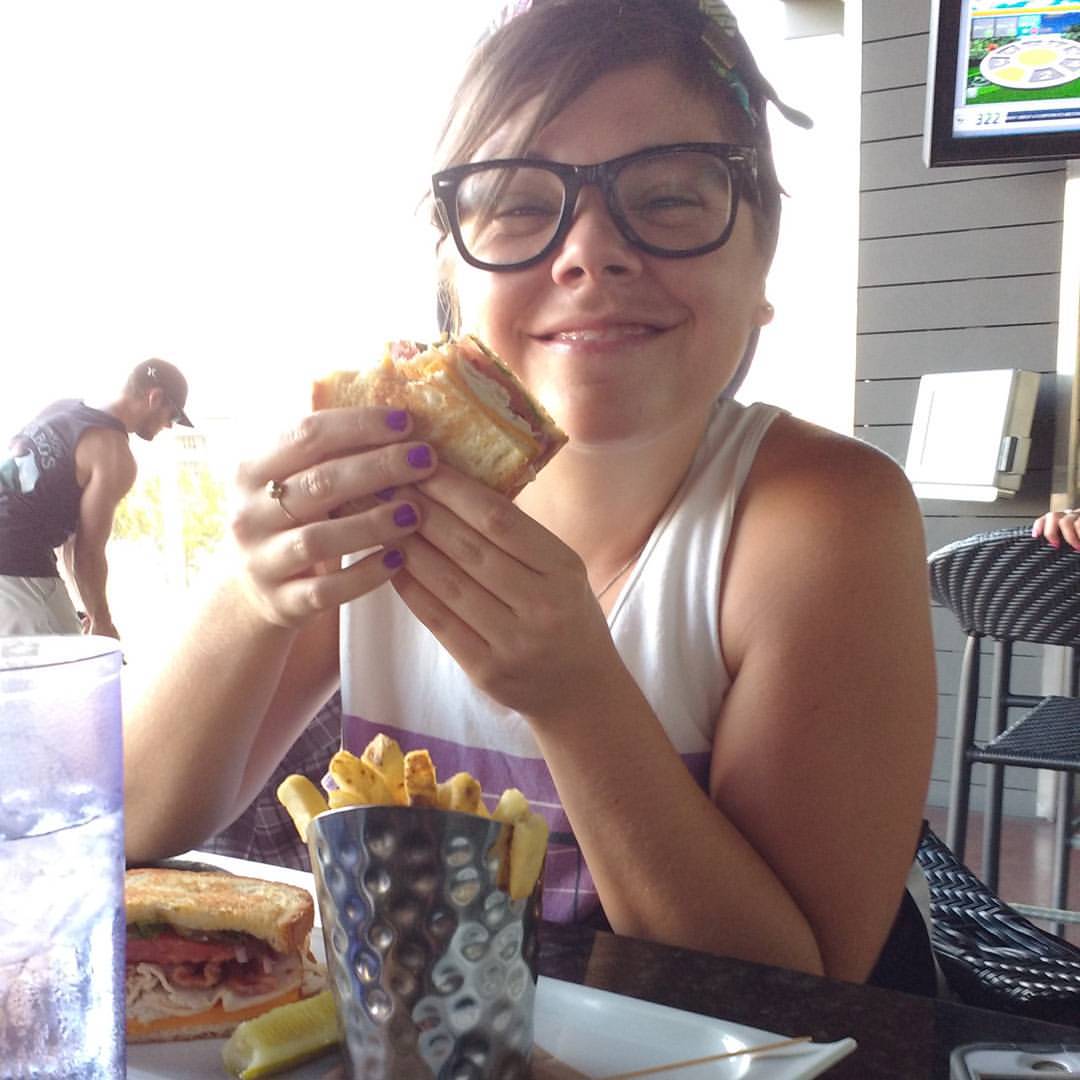 the woman is eating food with her glasses on
