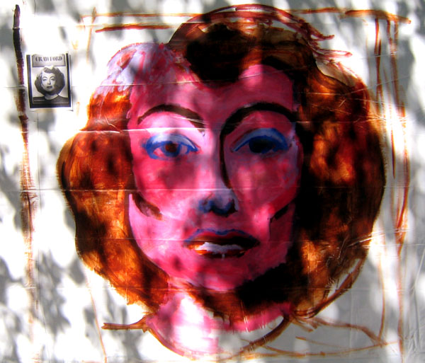 a pink and blue image of a woman's face on a wall