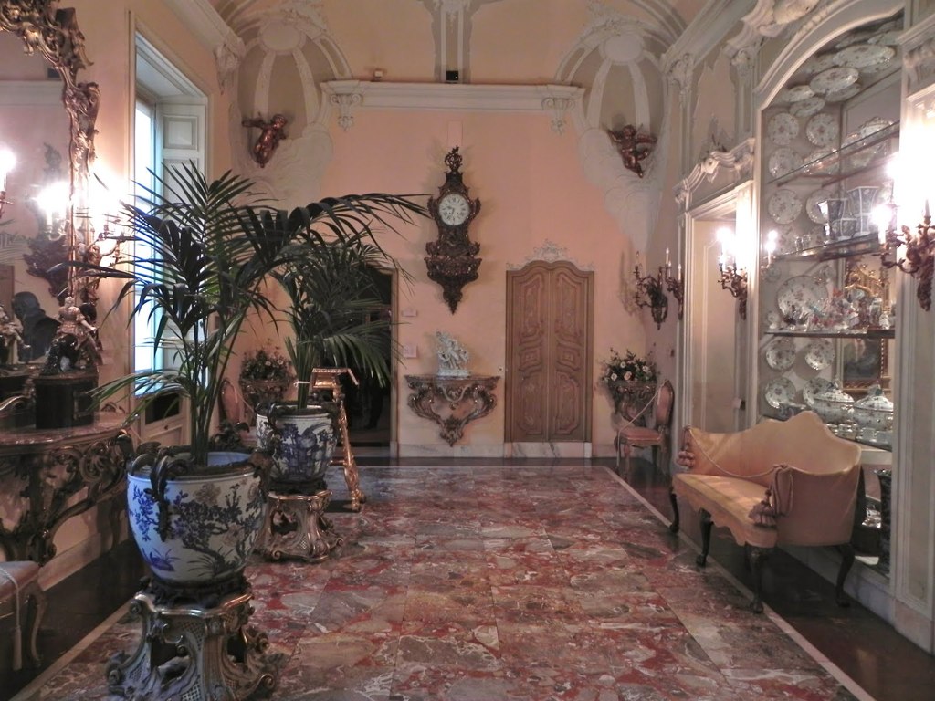 a very fancy house with two mirrors and big vases