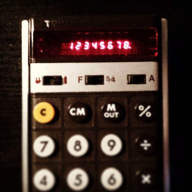 a calculator reads the date as it lies on top of a table