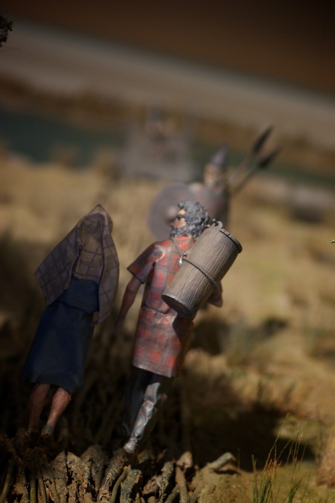 a close up of a figurine on a hill and a toy