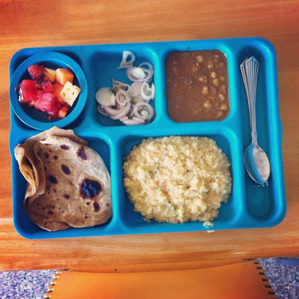 a blue tray filled with different kinds of food